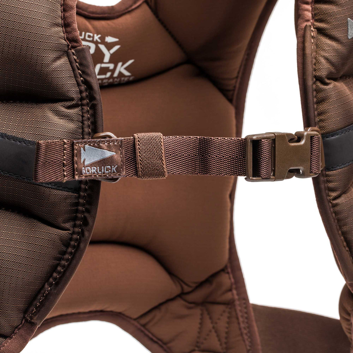 Close-up of a brown padded shoulder strap with a plastic buckle,