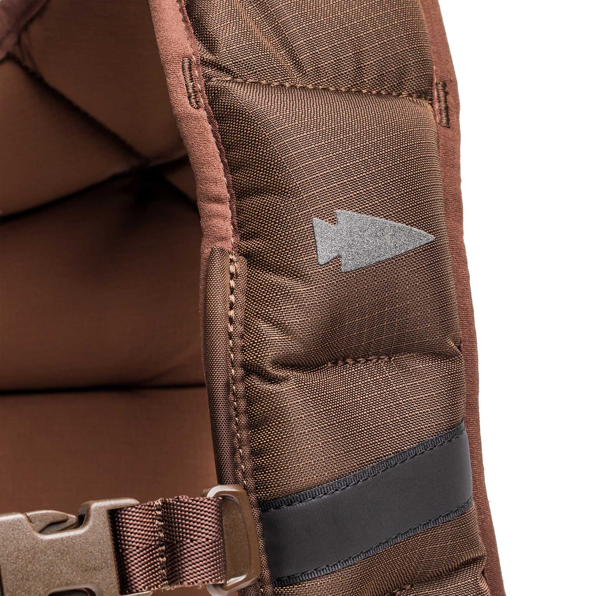 Close-up of a brown padded strap with gray arrow and black stripe, featuring a plastic buckle—designed for use with the Spy Ruck | Women's Weighted Vest.