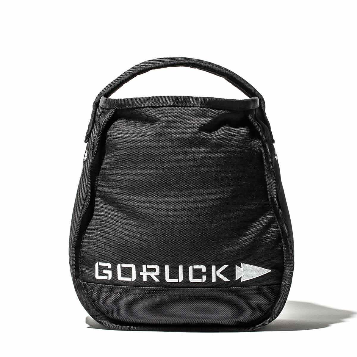 A GORUCK Sand Kettlebell in black, featuring handles on top and reflective lettering on the front, set against a white background, showcases an endurance design.