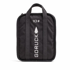 A rugged-textured Rucker bag in black from GORUCK, featuring two handles and adorned with GORUCK and 10 printed in white alongside an arrow design. The front showcases vertical stitching lines, and it comes with a lifetime guarantee for ultimate peace of mind.