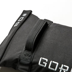 The Simple Training Sandbags feature a black design with a handle and white stitched "09" and "GOP" text—ideal for home gym workouts.