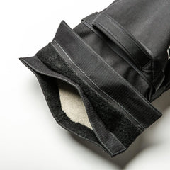 Close-up of a Simple Training Sandbags black fabric pouch with Velcro straps, partially open to reveal a soft, light-colored lining—perfect for home gym workouts.