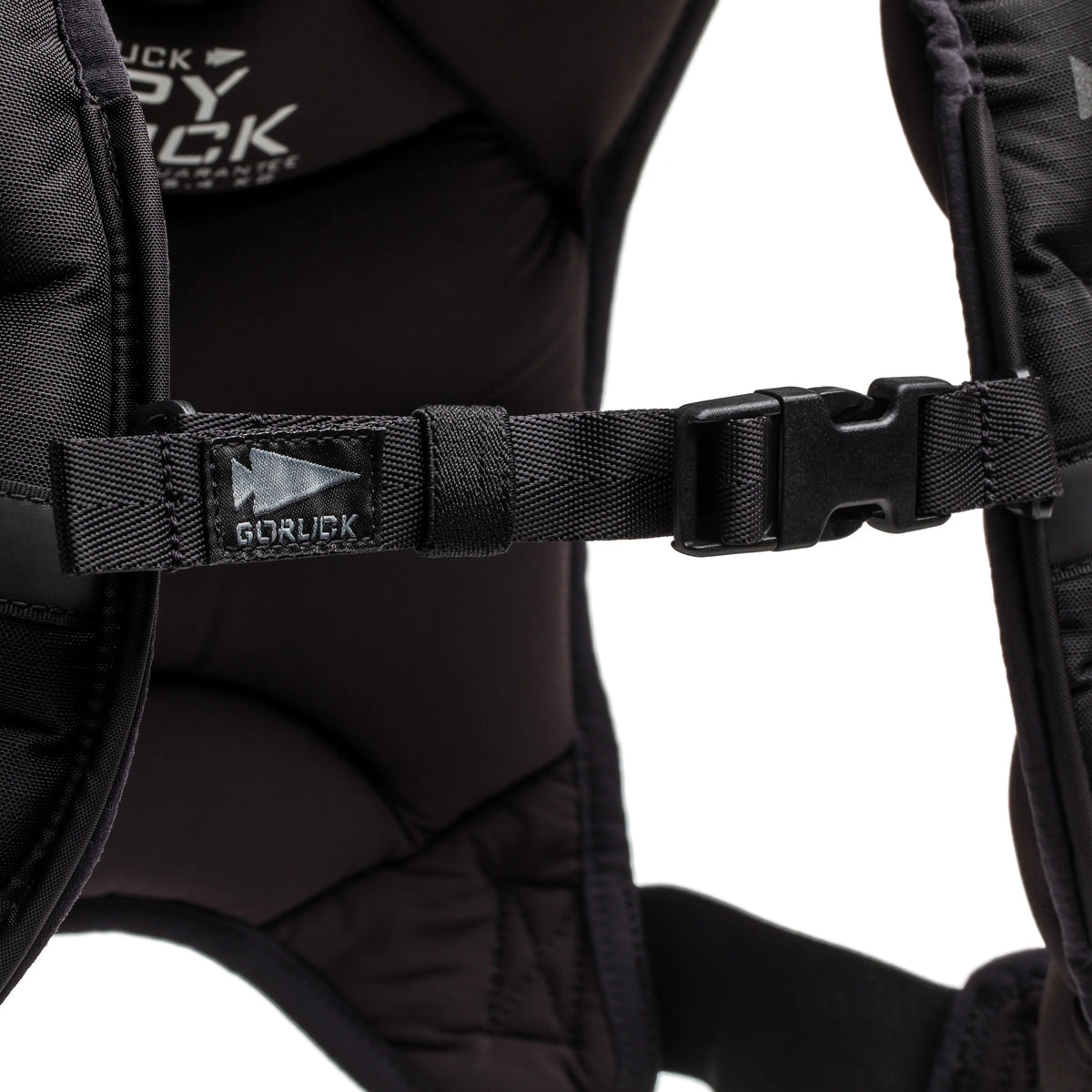 Close-up of a Spy Ruck chest strap with a plastic buckle and GORUCK logo on the left strap—ideal for women’s fitness or anyone wanting a versatile, weighted vest alternative.