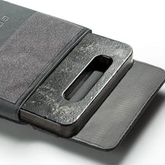 GORUCK ruck plate inserted in grey ruck plate carrier, tough workout gear on white background.